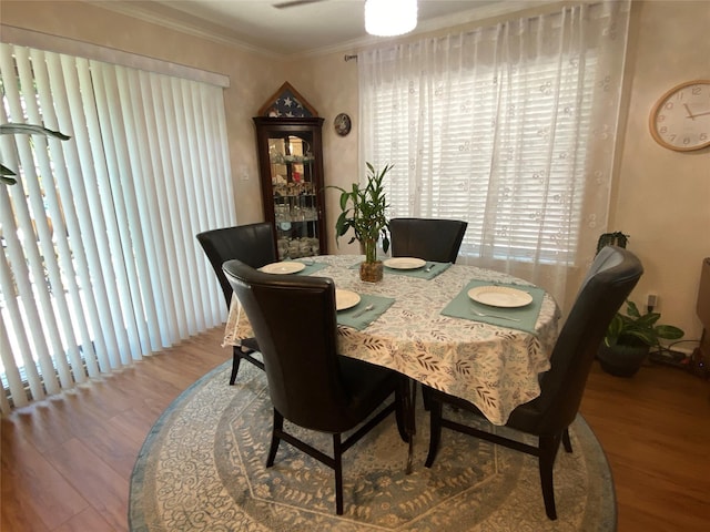 dining room featuring wood-type flooring and crown molding