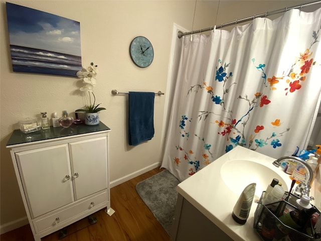 bathroom with a shower with shower curtain, wood-type flooring, and vanity