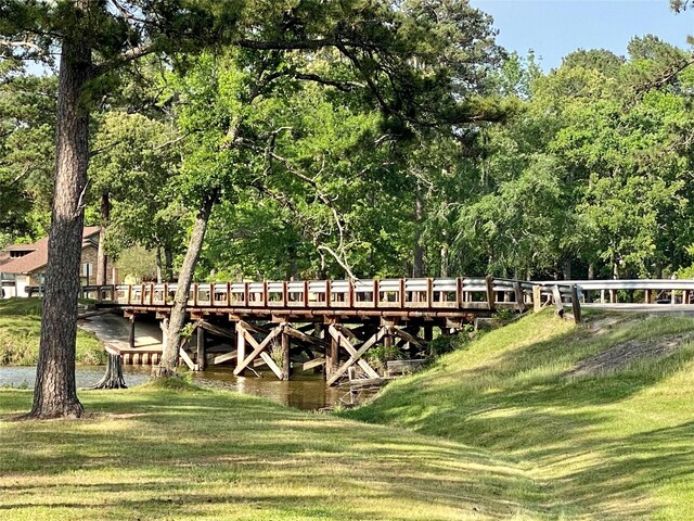 view of dock featuring a lawn