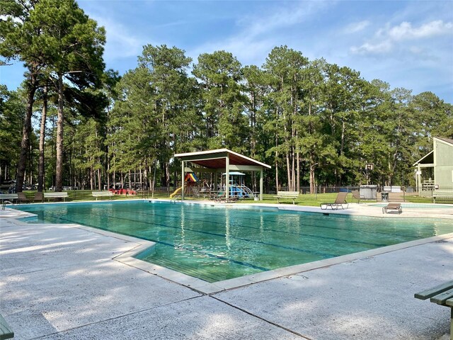 view of swimming pool with a playground