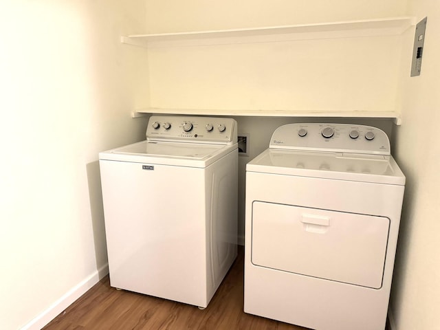 laundry room featuring separate washer and dryer and hardwood / wood-style flooring