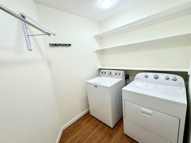 36 Corkwood Rd, Trinity, TX 75862 - laundry room featuring baseboards, laundry area, washing machine and clothes dryer, and wood finished floors