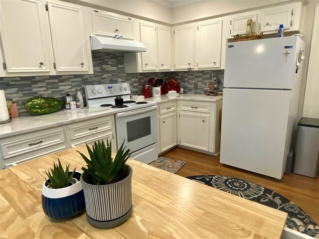 36 Corkwood Rd, Trinity, TX 75862 - kitchen with light countertops, white appliances, under cabinet range hood, white cabinetry, and decorative backsplash