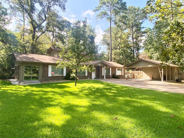 36 Corkwood Rd, Trinity, TX 75862 - view of front of house with concrete driveway, an attached carport, a front lawn, and brick siding
