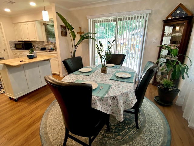 36 Corkwood Rd, Trinity, TX 75862 - dining area featuring ornamental molding and wood finished floors