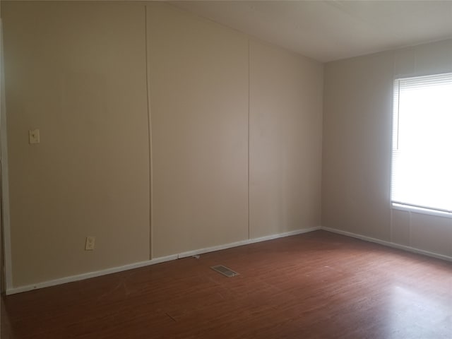 unfurnished room featuring wood-type flooring