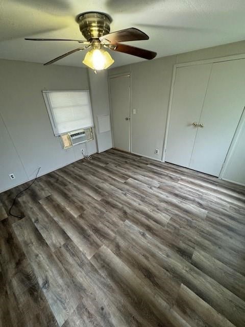 unfurnished bedroom featuring ceiling fan, a closet, and wood-type flooring