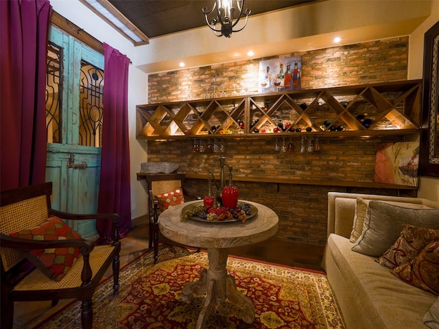 wine cellar featuring a notable chandelier and hardwood / wood-style flooring