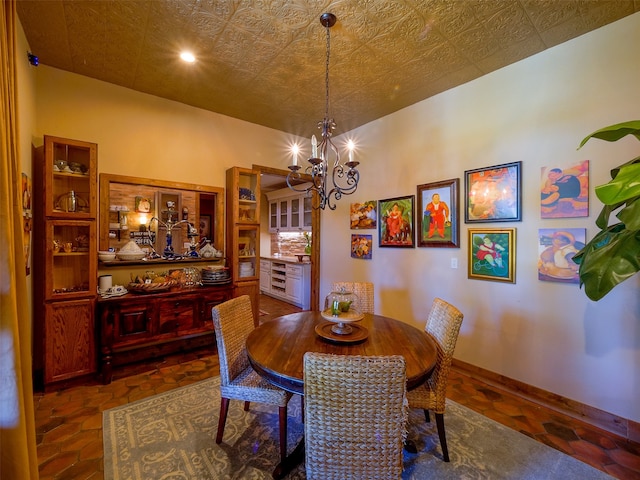 dining room featuring a chandelier and dark tile patterned floors