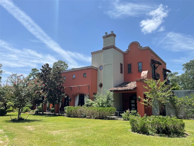 rear view of property with a lawn