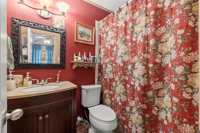 bathroom featuring ceiling fan, toilet, and vanity