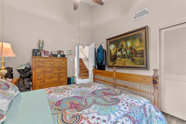 bedroom with ceiling fan, a closet, and dark wood-type flooring