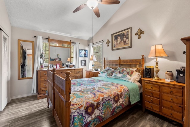 bedroom with dark hardwood / wood-style floors, a closet, ceiling fan, and lofted ceiling