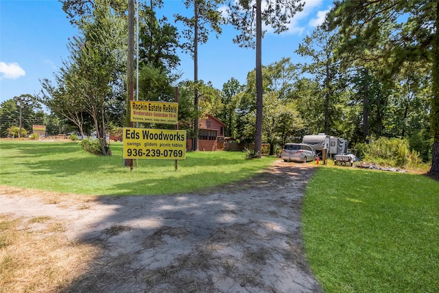 community / neighborhood sign featuring a yard