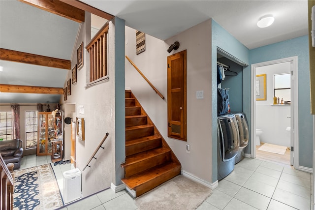 stairway featuring light tile floors, washing machine and dryer, and beamed ceiling