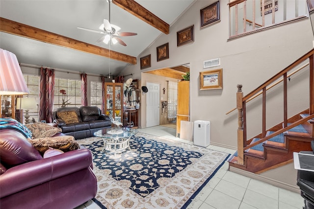 tiled living room featuring ceiling fan, beamed ceiling, and high vaulted ceiling