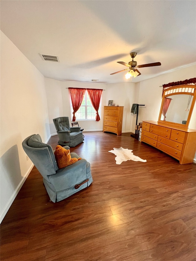 sitting room with ceiling fan and dark hardwood / wood-style floors