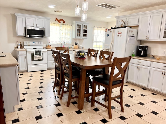 dining room featuring light tile flooring and a chandelier