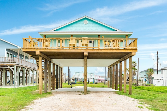 exterior space featuring a wooden deck and a lawn