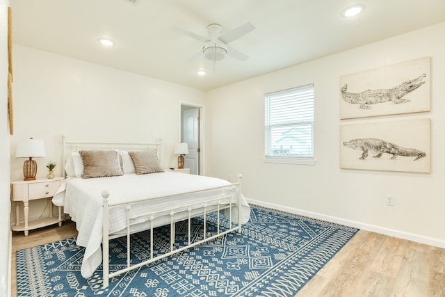 bedroom featuring ceiling fan and light hardwood / wood-style flooring