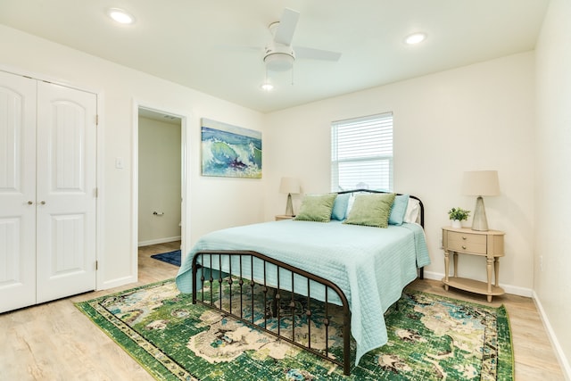 bedroom with ceiling fan, a closet, and light wood-type flooring