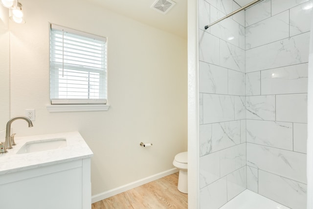 bathroom featuring toilet, hardwood / wood-style flooring, and vanity