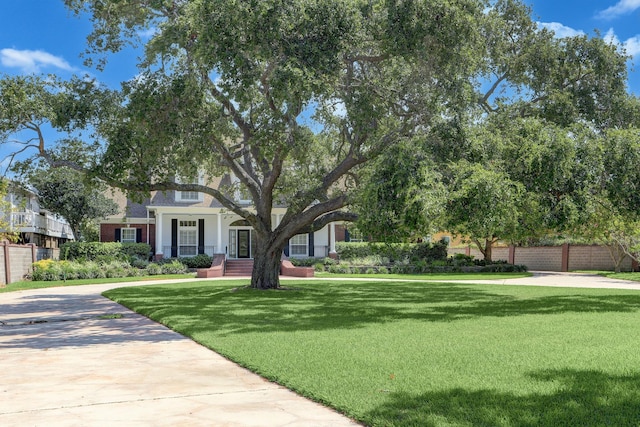 view of front of property with covered porch and a front lawn