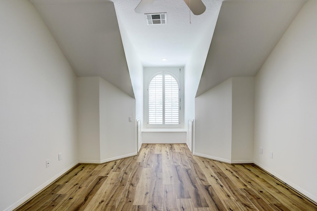 bonus room featuring ceiling fan and light wood-type flooring