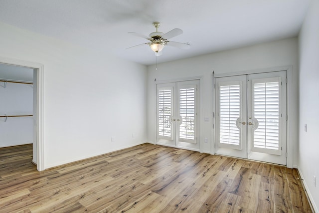 spare room featuring ceiling fan, light hardwood / wood-style floors, and french doors