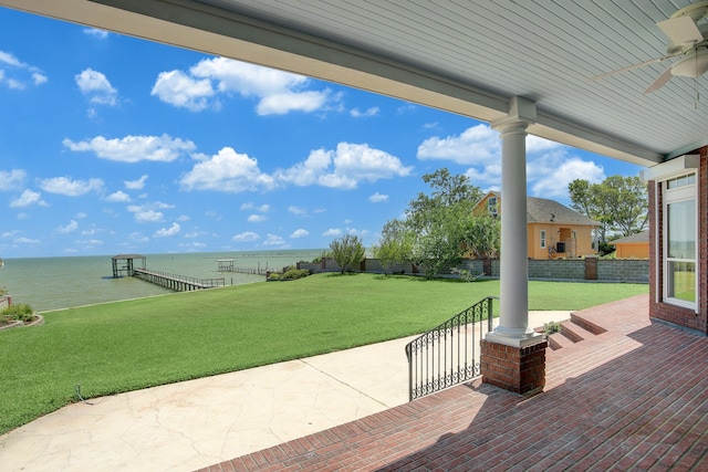 view of patio featuring ceiling fan and a water view