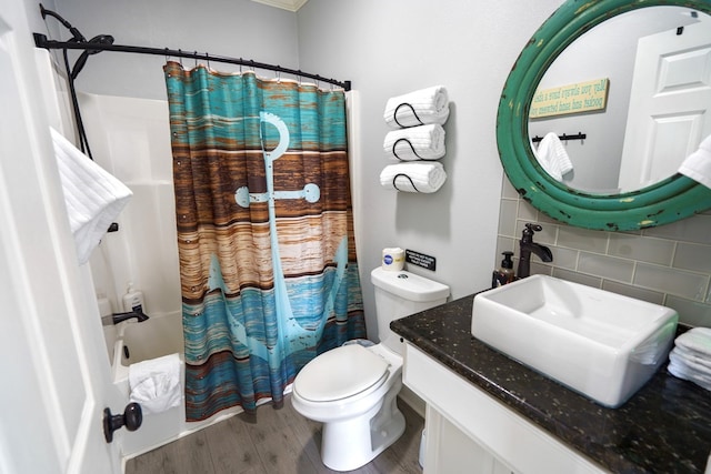 full bathroom with toilet, large vanity, tile walls, wood-type flooring, and backsplash