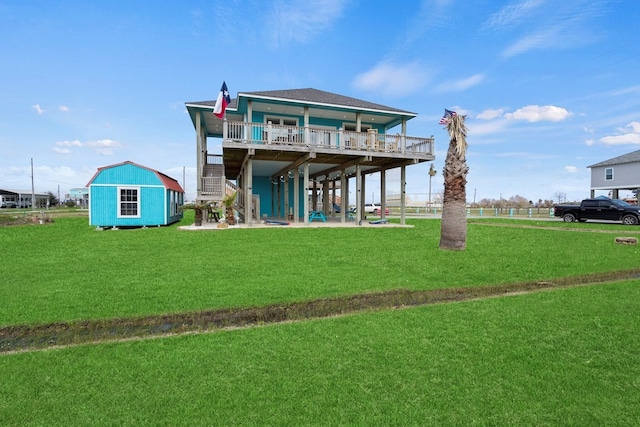 back of property with a storage shed and a yard