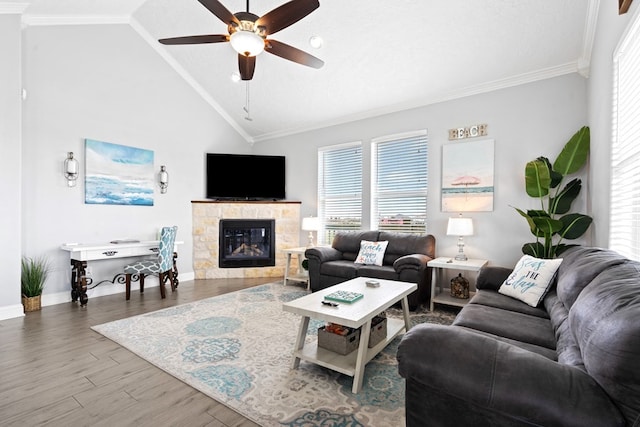 living room with lofted ceiling, light hardwood / wood-style floors, ceiling fan, and ornamental molding