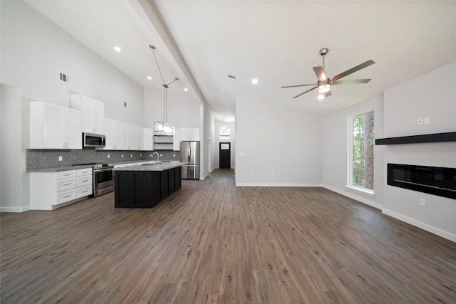 kitchen featuring white cabinetry, visible vents, open floor plan, and stainless steel appliances