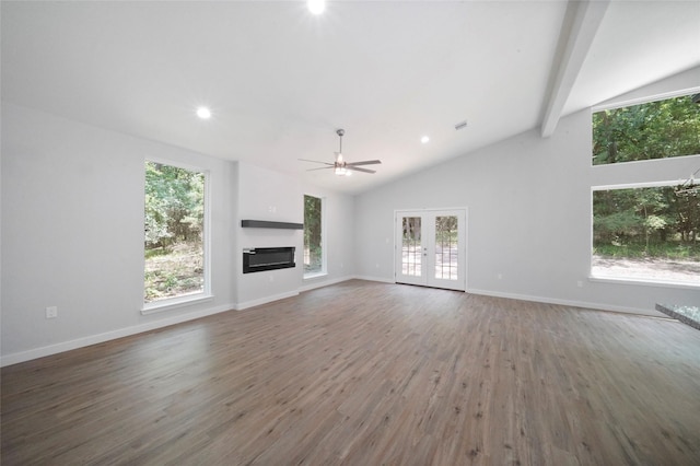 unfurnished living room with plenty of natural light, a ceiling fan, and wood finished floors