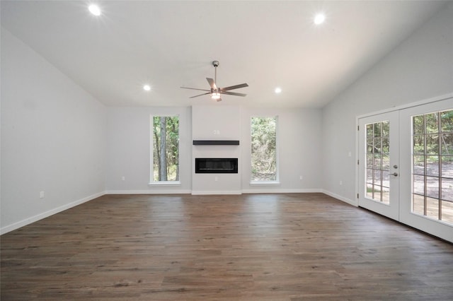 unfurnished living room featuring a ceiling fan, vaulted ceiling, dark wood-style floors, and french doors