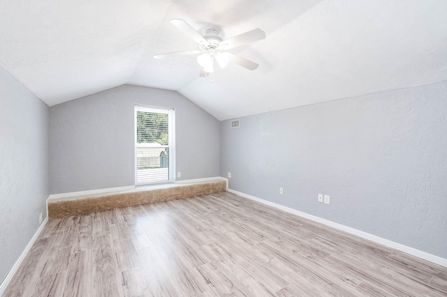 bonus room with ceiling fan, light hardwood / wood-style flooring, and vaulted ceiling