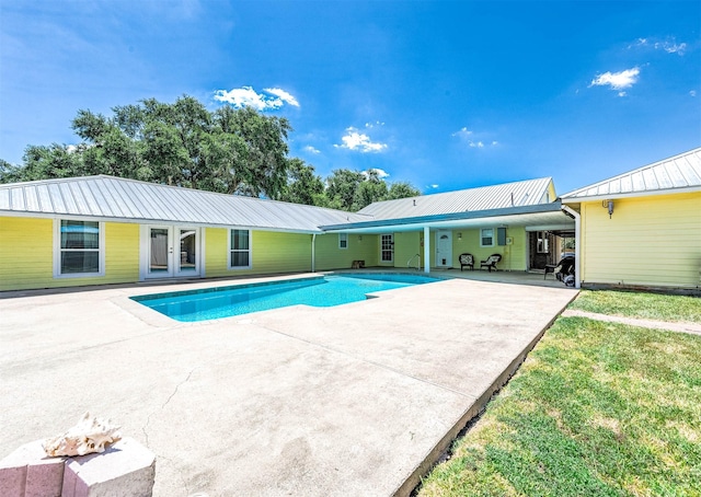 view of swimming pool featuring a yard and a patio