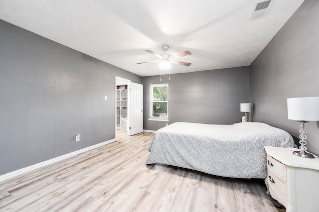 bedroom with light wood-type flooring and ceiling fan