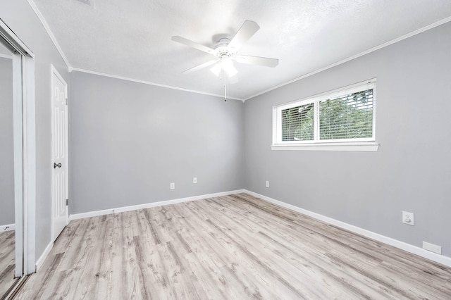 spare room with ceiling fan, crown molding, a textured ceiling, and light hardwood / wood-style floors