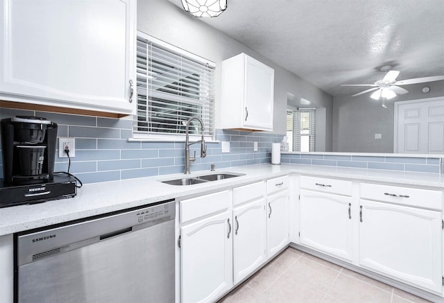 kitchen featuring white cabinetry, stainless steel dishwasher, and sink