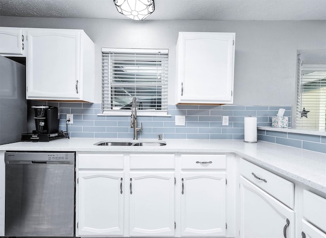 kitchen with backsplash, dishwasher, a textured ceiling, white cabinets, and sink