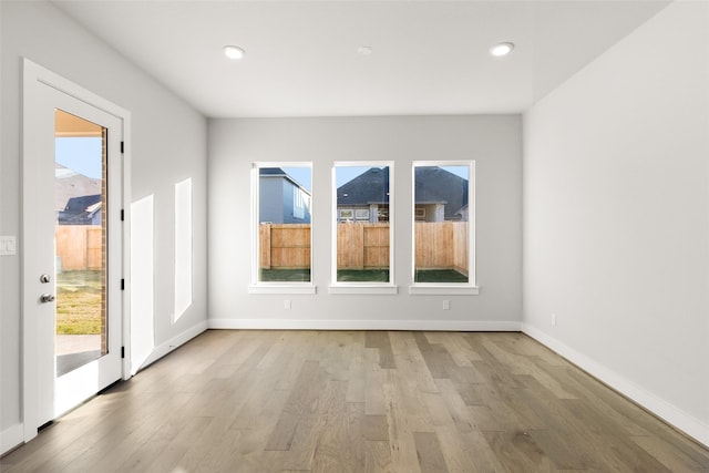 unfurnished room with light hardwood / wood-style floors