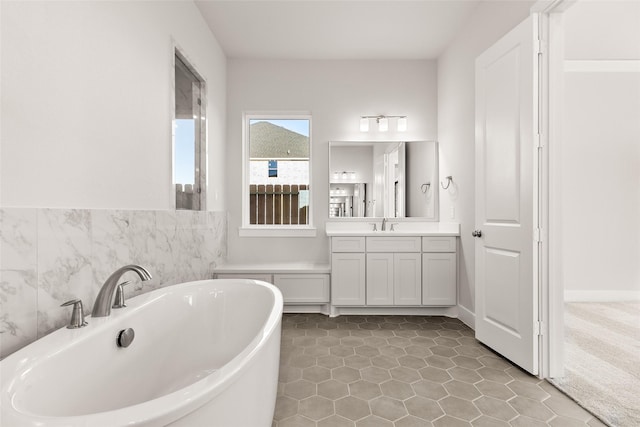 bathroom featuring tile patterned flooring, vanity, and a tub