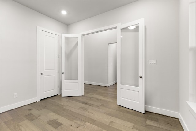 unfurnished bedroom featuring a closet and light wood-type flooring