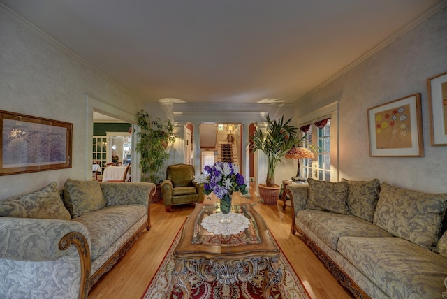 living room with ornamental molding and light hardwood / wood-style flooring