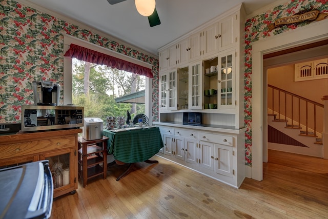 office with ceiling fan and light hardwood / wood-style flooring