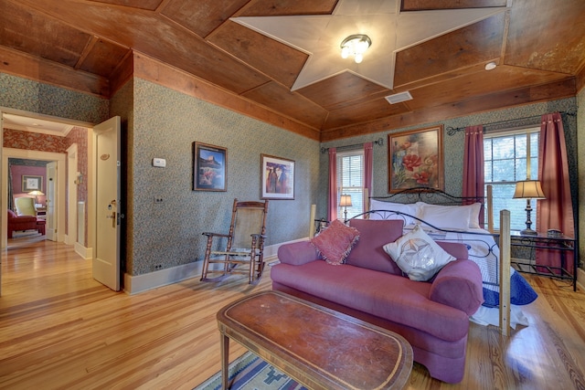 bedroom with light hardwood / wood-style floors, wood ceiling, and vaulted ceiling