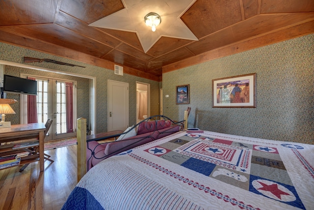 bedroom with french doors, hardwood / wood-style floors, lofted ceiling, and wood ceiling