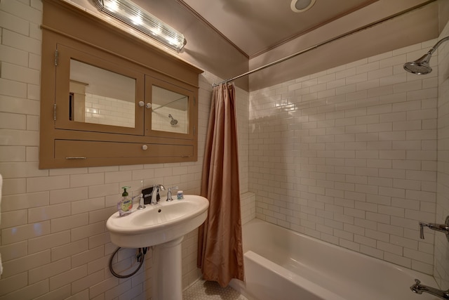 bathroom featuring shower / bath combo with shower curtain and tile walls